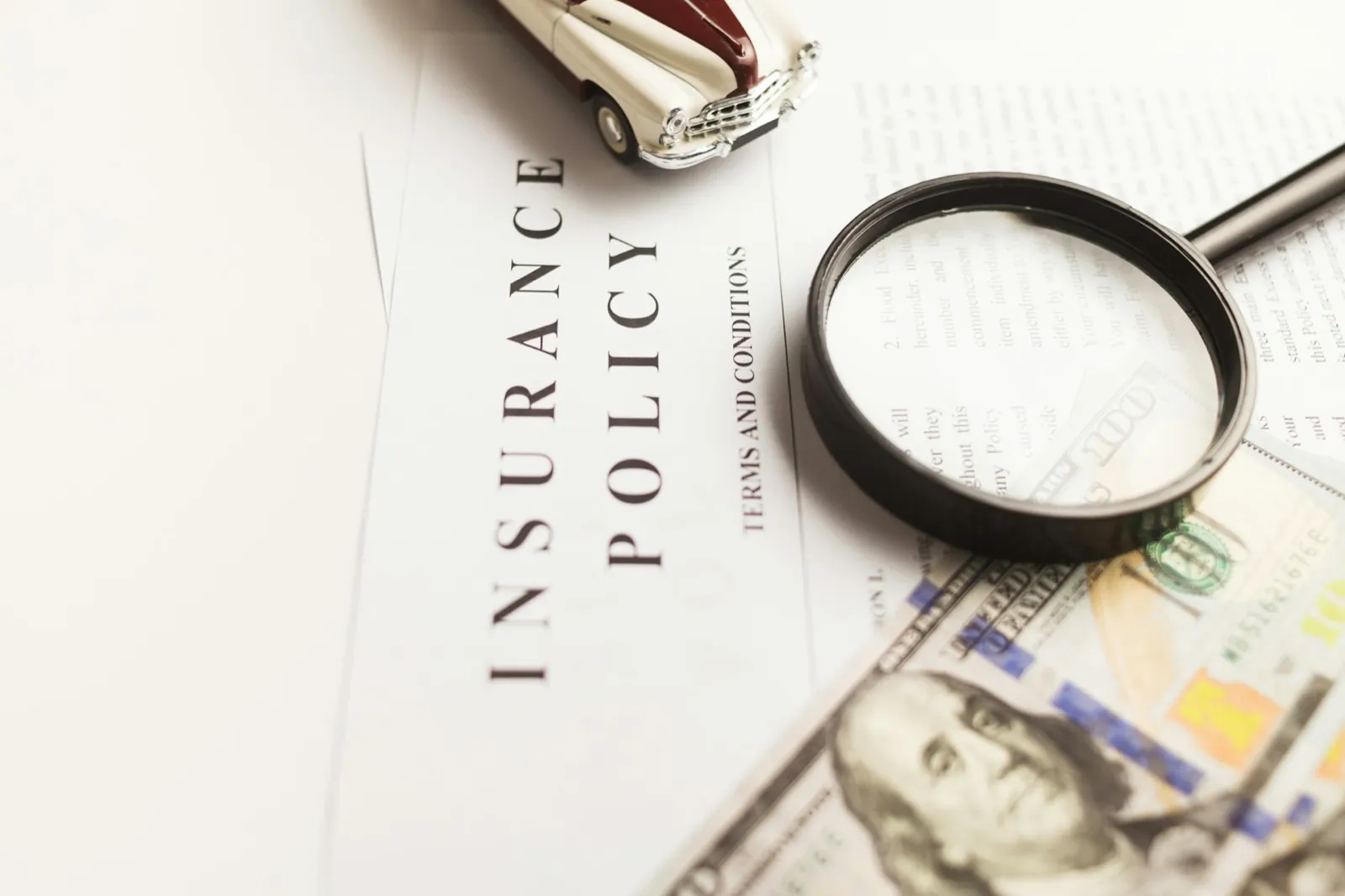 Magnifying glass resting on a stack of paperwork