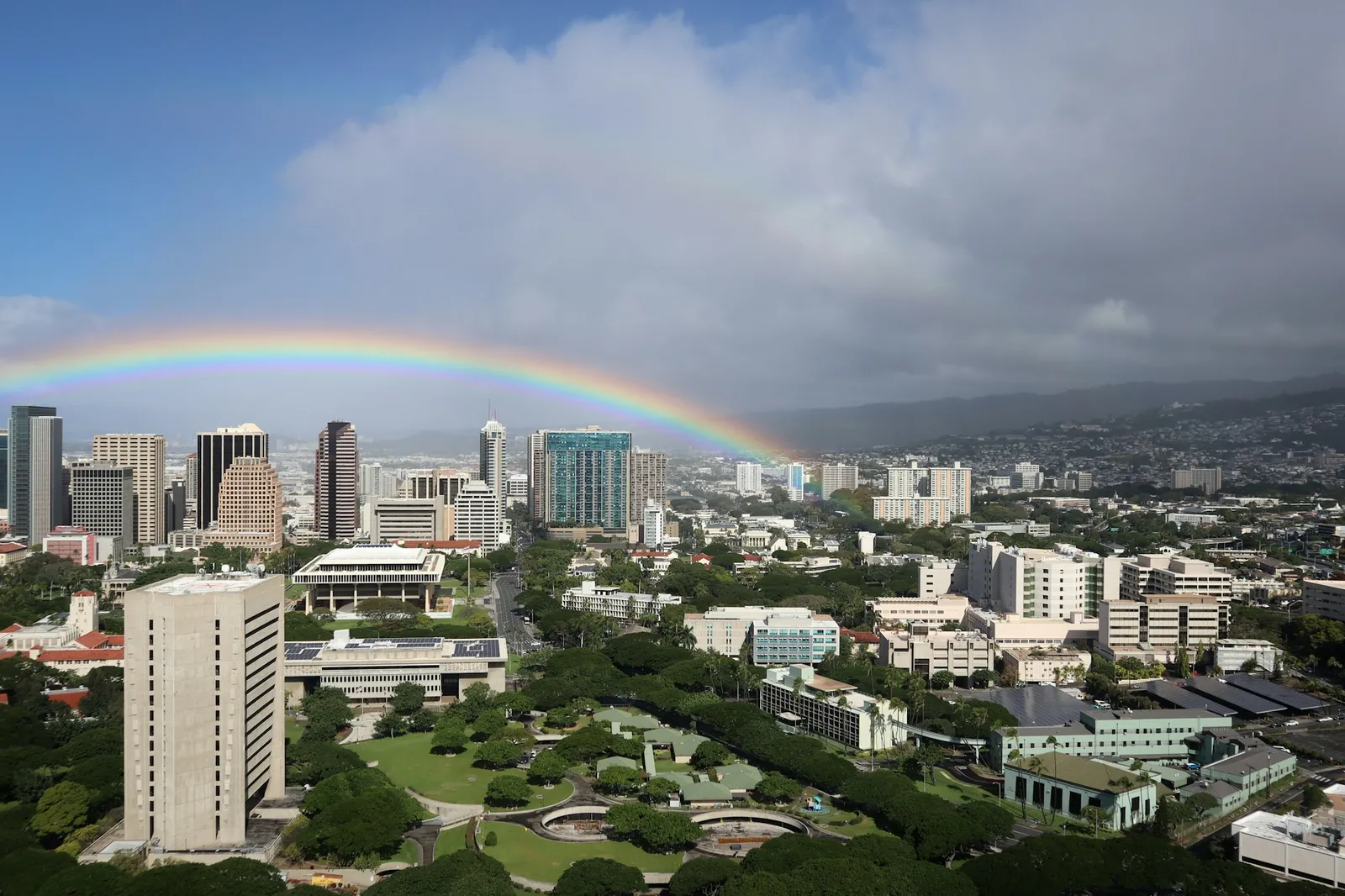 A rainbow over city buildings