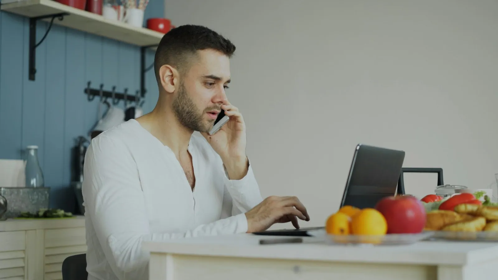 Man talking on the phone while working at a desk