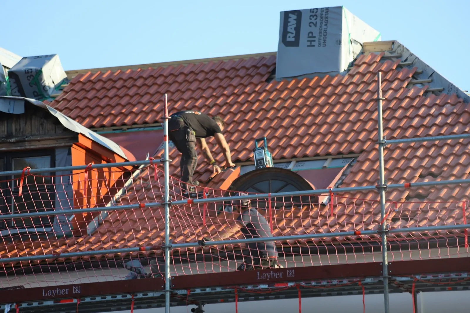 Worker on a roof doing repairs