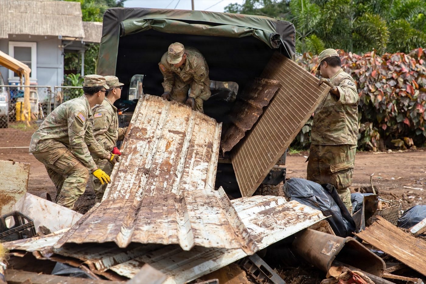 Guard members loading flood-damaged contents and debris from Waialua homes onto trucks, March 28, 2026