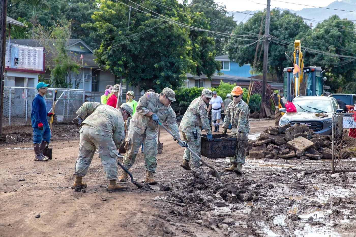 Hawaii National Guard members clearing mud and flood debris from a Waialua home, March 26, 2026