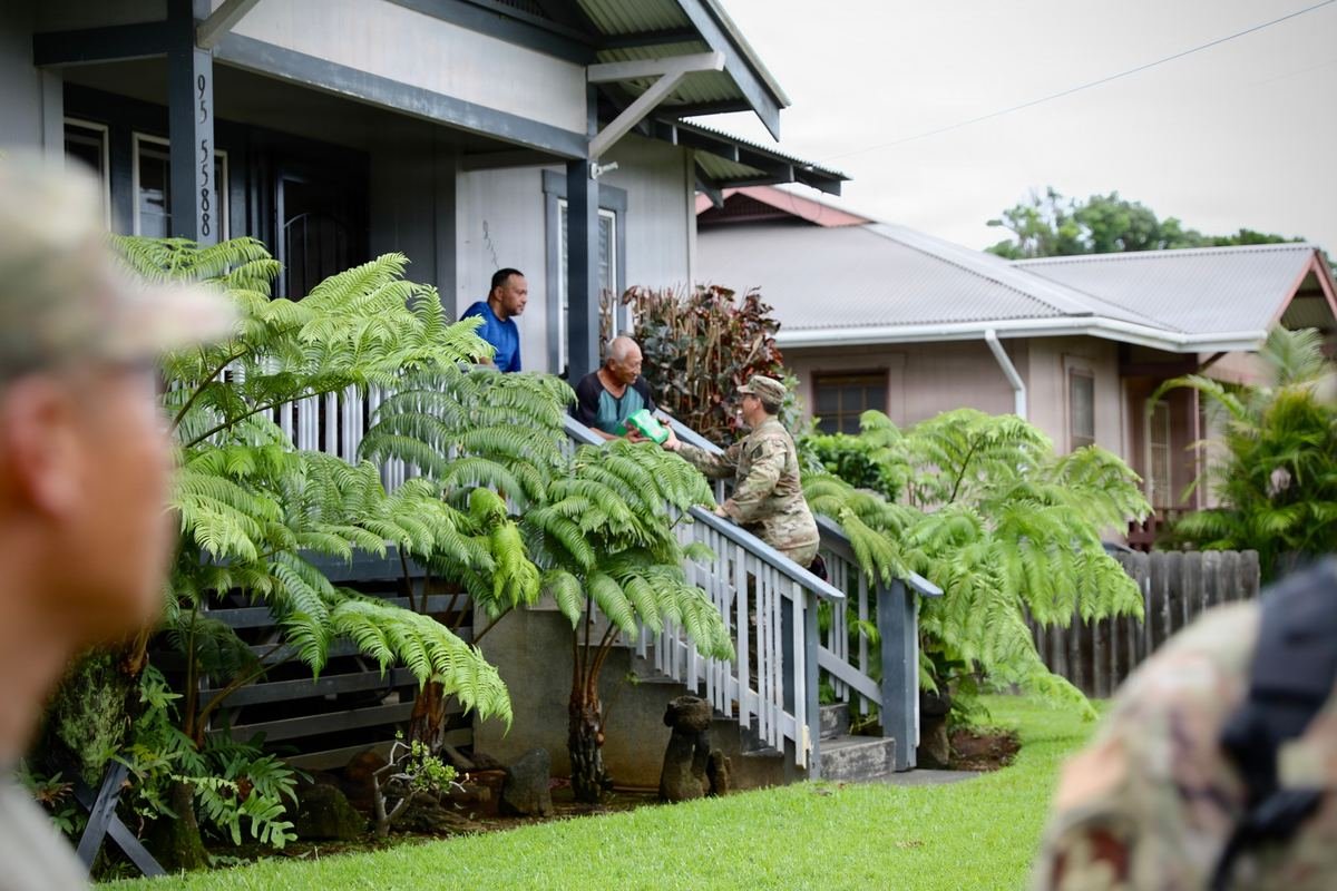 A Hawaii National Guard member checking on residents at their home after Hurricane Lala