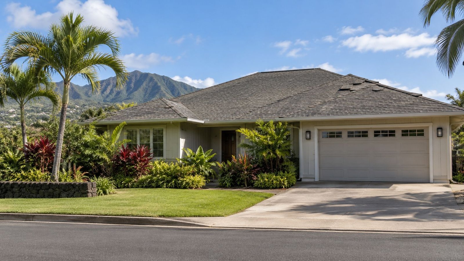 Hawaii home that looks fine from the street after a storm, with only subtle roof damage