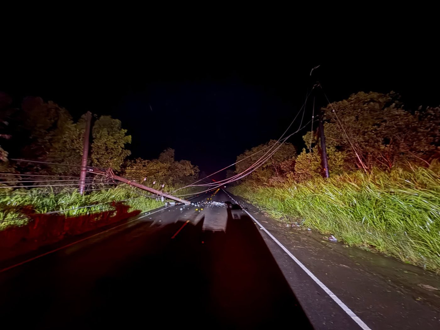 Utility poles and lines downed by Hurricane Lowell near mile marker 17 on Kūhiō Highway in Moloaʻa, Kauaʻi