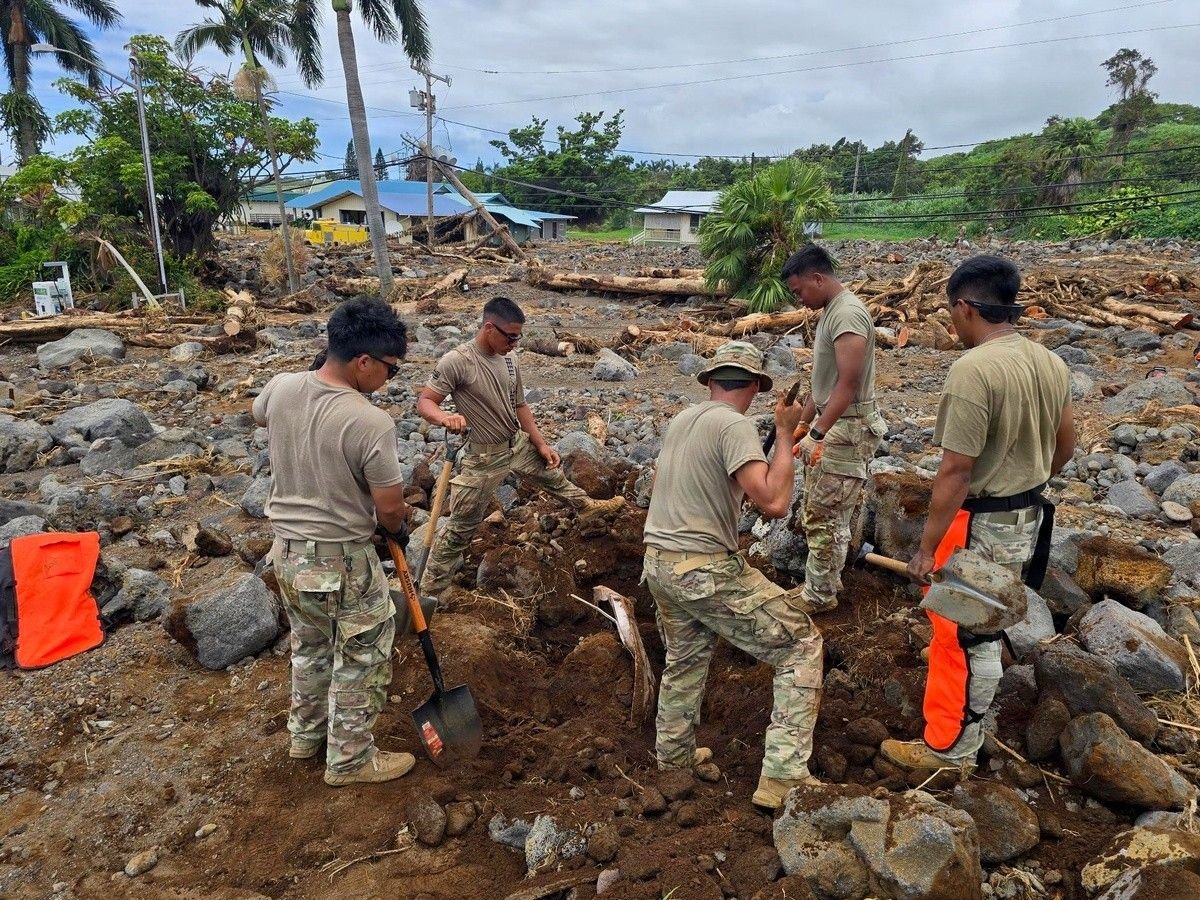 Hawaiʻi National Guard soldiers clear rocks and debris from a debris flow between homes in Nāʻālehu, Kaʻū, after Hurricane Lala, September 2, 2026