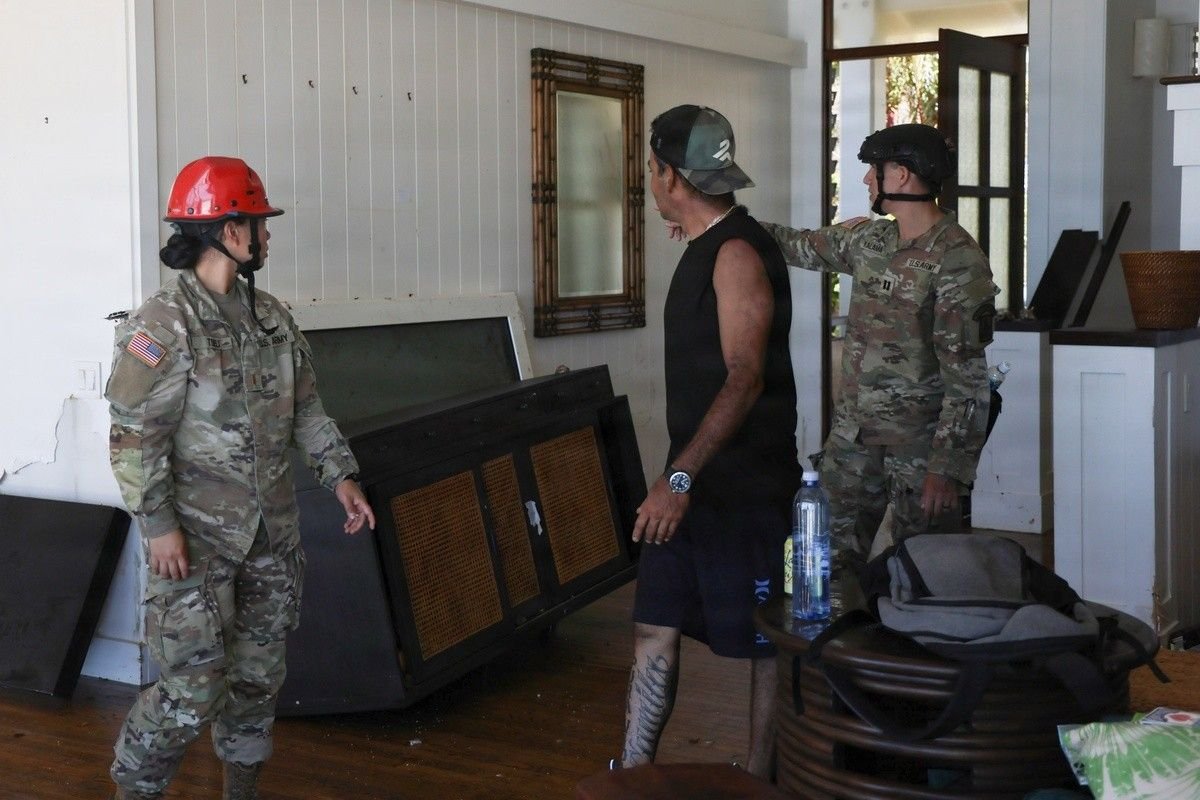 A Poʻipū homeowner shows Hawaiʻi National Guard soldiers the storm damage inside his home after Hurricane Lowell, September 9, 2026